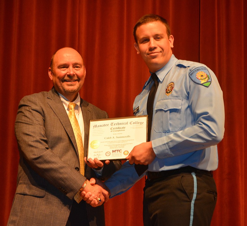 Caleb Summeralls receives his certificate for completing the Florida Law Enforcement Academy at Manatee Technical College.