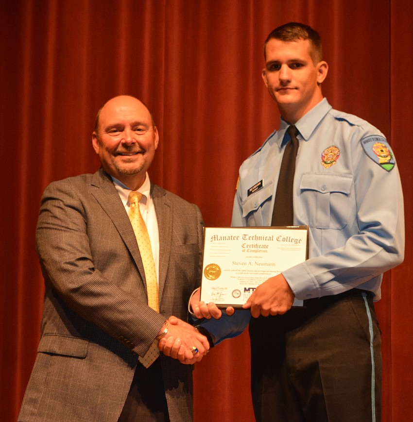 Steven Neumann receives his certificate for completing the Florida Law Enforcement Academy at Manatee Technical College.