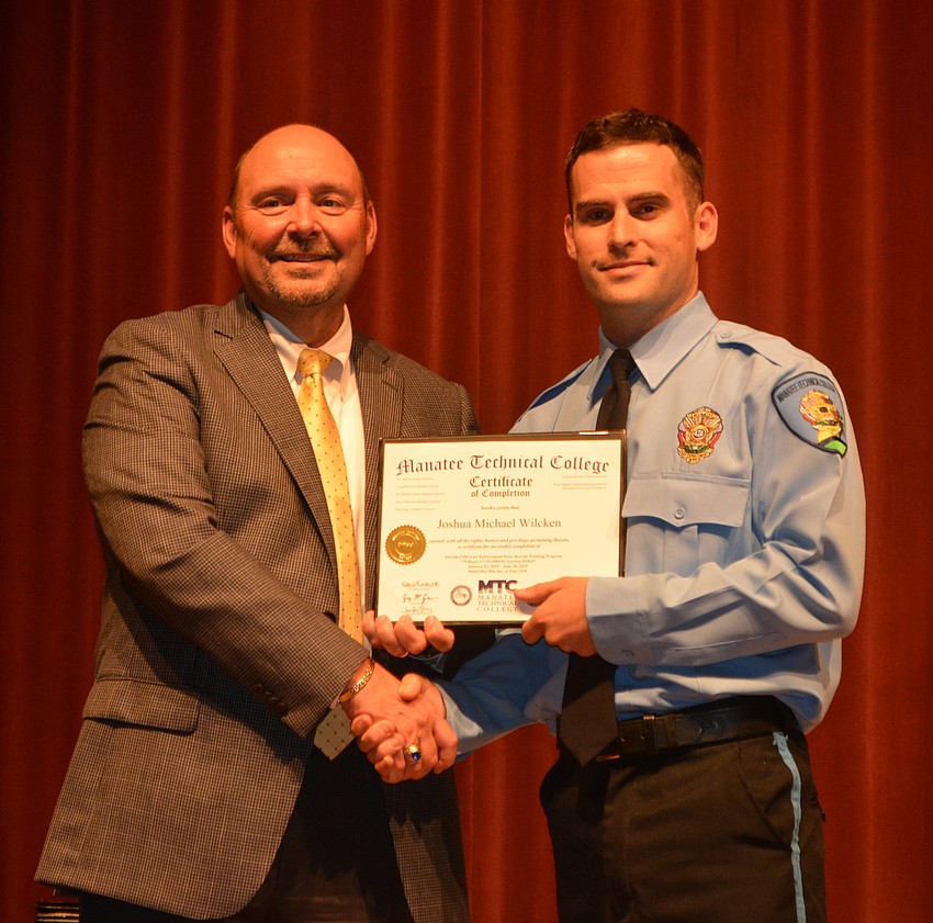 Joshua Wilcken receives his certificate for completing the Florida Law Enforcement Academy at Manatee Technical College.