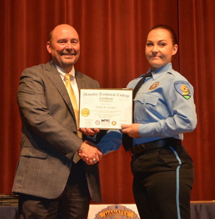 Shelby Gardner receives her certificate for completing the Florida Law Enforcement Academy at Manatee Technical College.