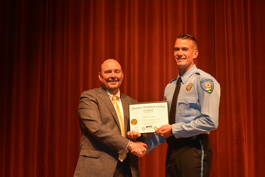 Nathan Lynn receives his certificate for completing the Florida Law Enforcement Academy at Manatee Technical College.