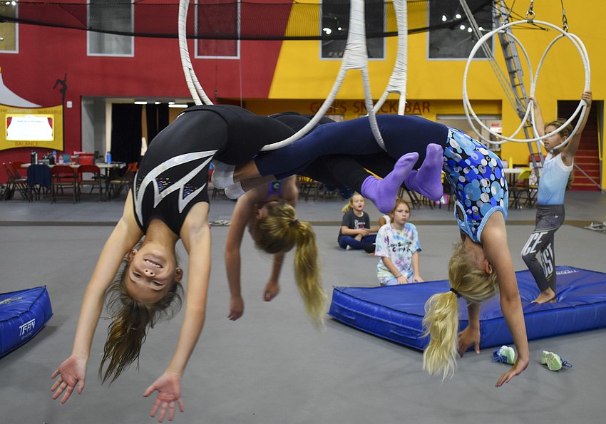 Polly Teffenhart, Annabelle Budslick and Cecilia Galanis practice their triple lyra routine