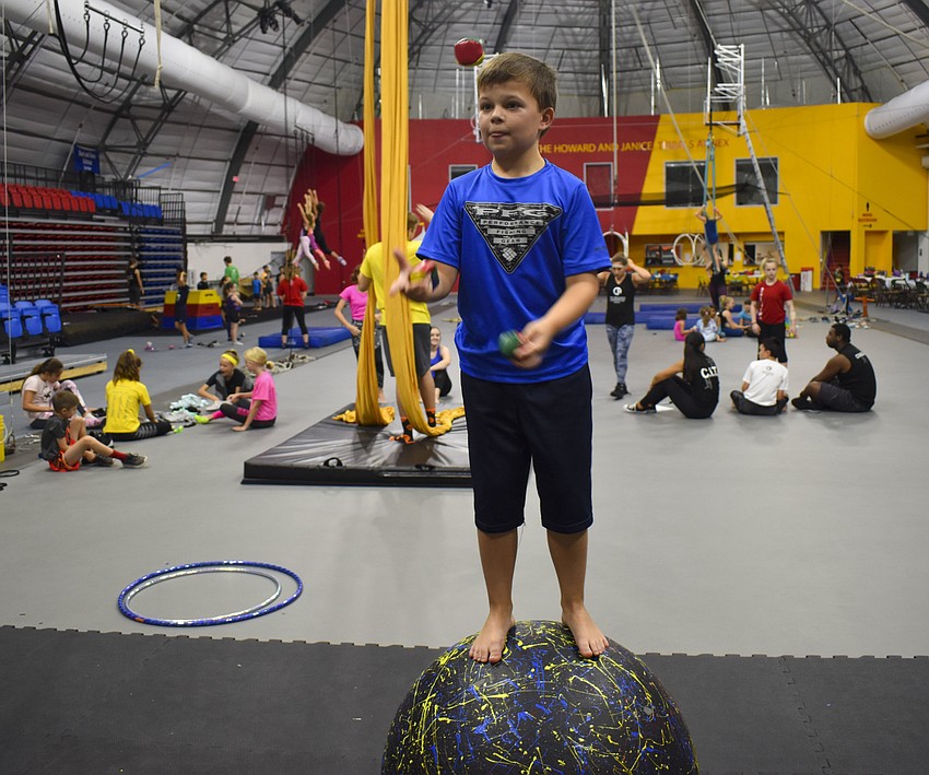Tom Bergerat, 10, is on top of the world as he juggles while walking on a ball at Circus Arts Conservatory’s summer camp June 19.