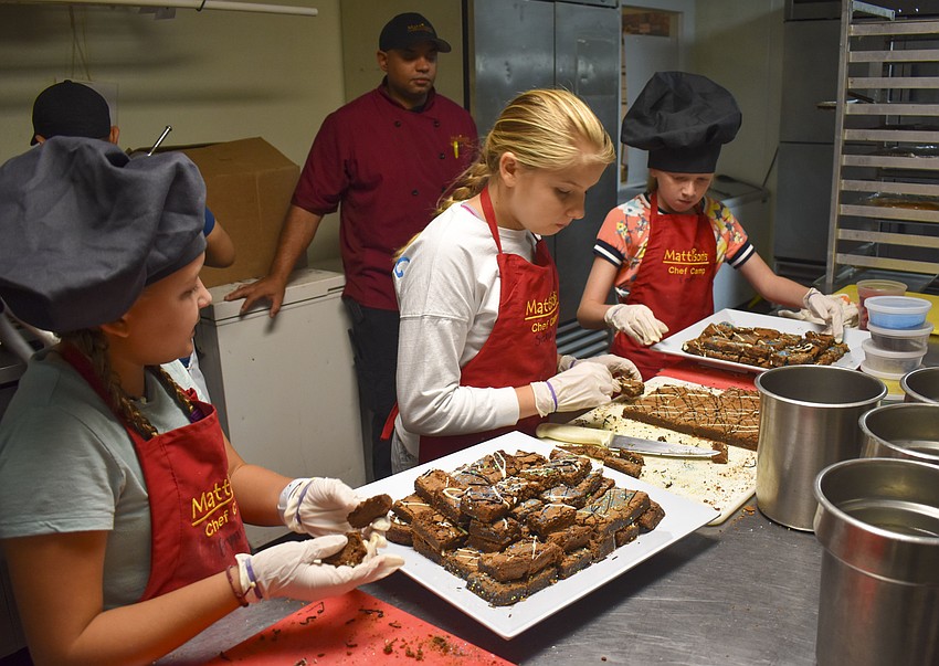 Brynn DeJongh, Sienna Steiner and Emma Elfenbein plate the brownies they made.