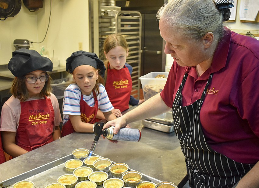 Chef May Cavazos shows the kids how to use a culinary torch to make crème brûlée.