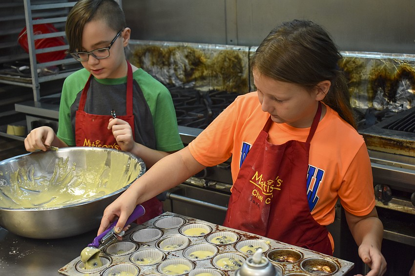 Desmond Pizzo and Sarah Gray prepare blueberry muffins.