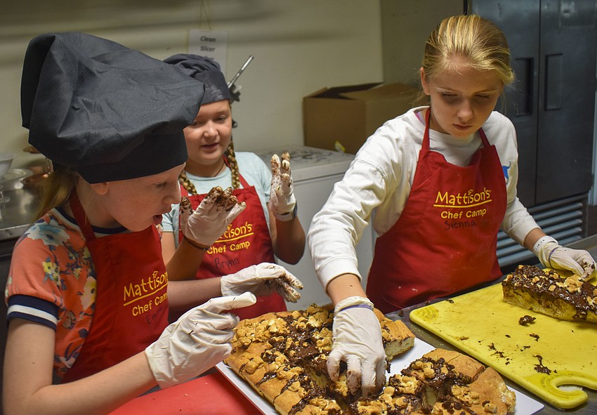 Emma Elfenbein, Brynn DeJongh and Sienna Steiner plate the s'mores focaccia bread.