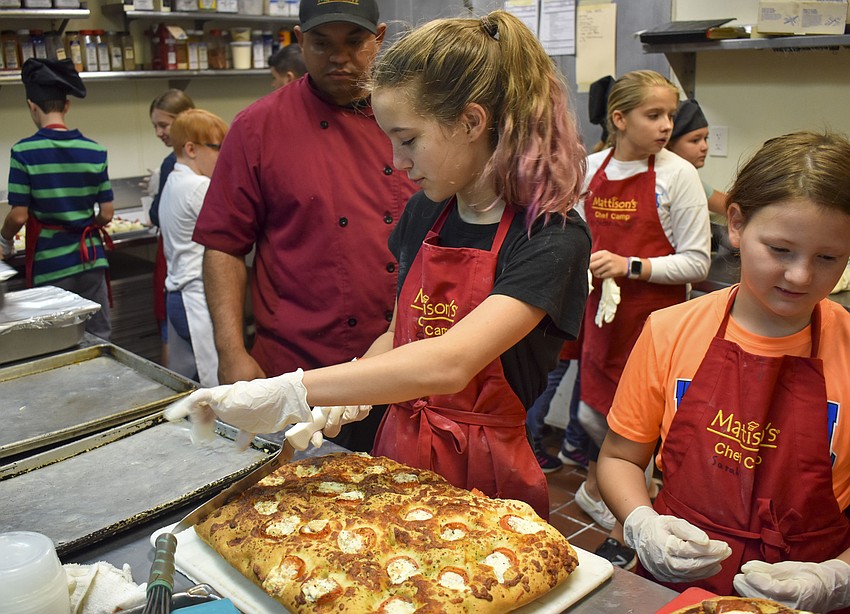 Spencer Schurawell cuts focaccia bread.