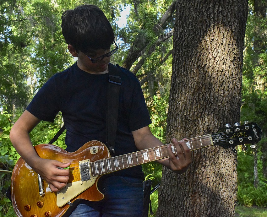 Miguel Rodriquez-Diaz plays guitar during a Burning Burritos performance.