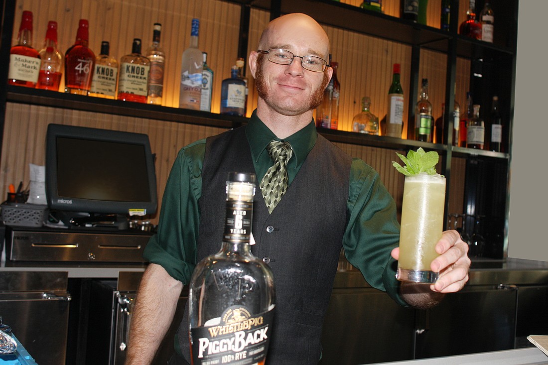 Libby&#39;s bartender Mike Madison poses with his piggyback smash. Photo by Su Byron