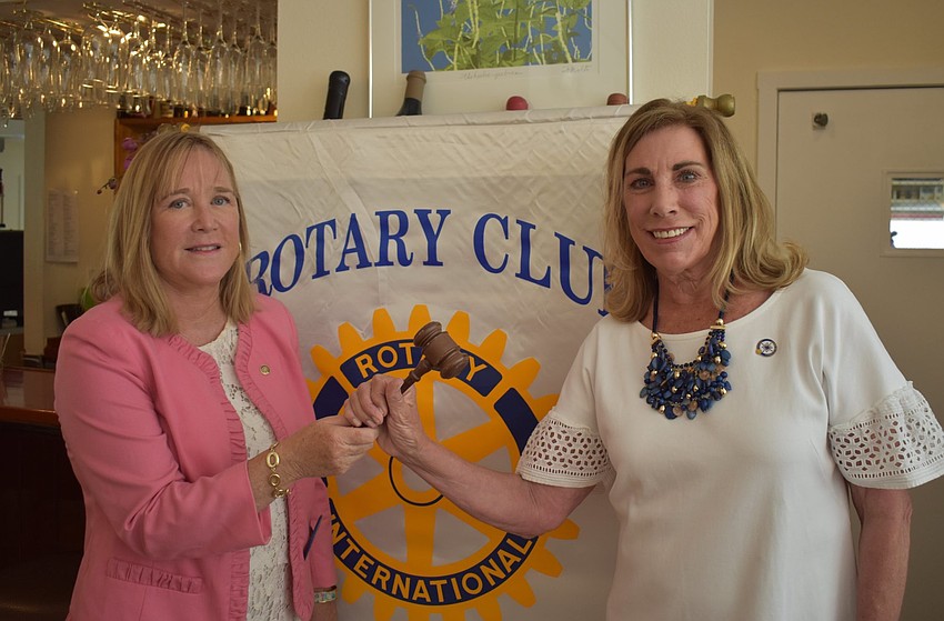 Susan McGuire and Nancy Rozance both hold the Longboat Key Rotary Club gavel.