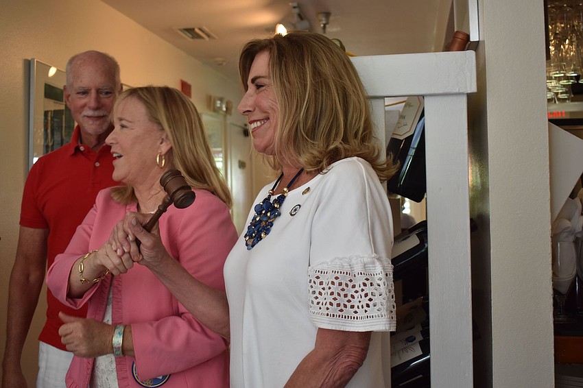 The gavel is literally passed from Susan McGuire to Nancy Rozance.