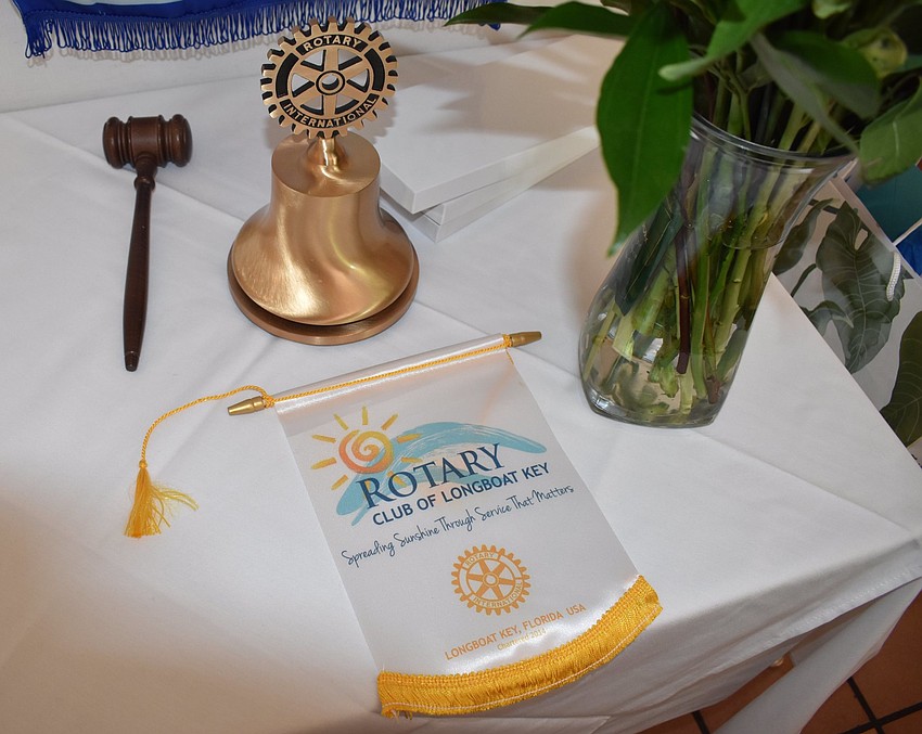 The all-important gavel of the Longboat Key Rotary Club rests alongside a bell and the club's flag.