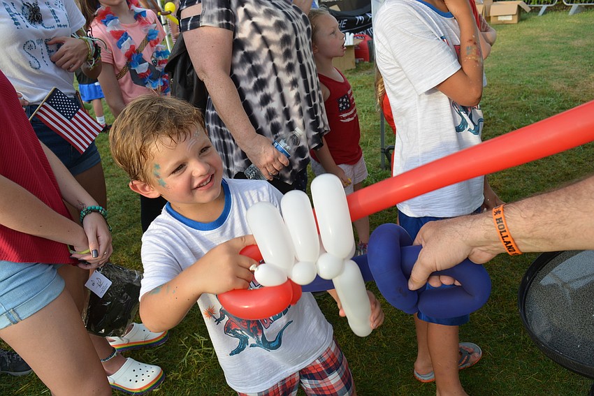 Four-year-old Keltin Gwin, of West Palm Beach, battles with his new balloon sword.