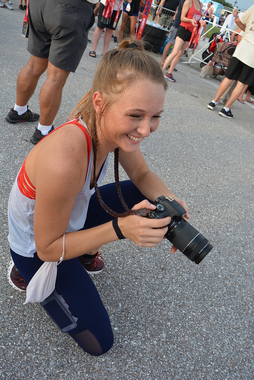 Heritage Harbour's Carsyn Schares photographs runners for Fit2Run as they complete the Fireworks 4-Miler On The Lake.