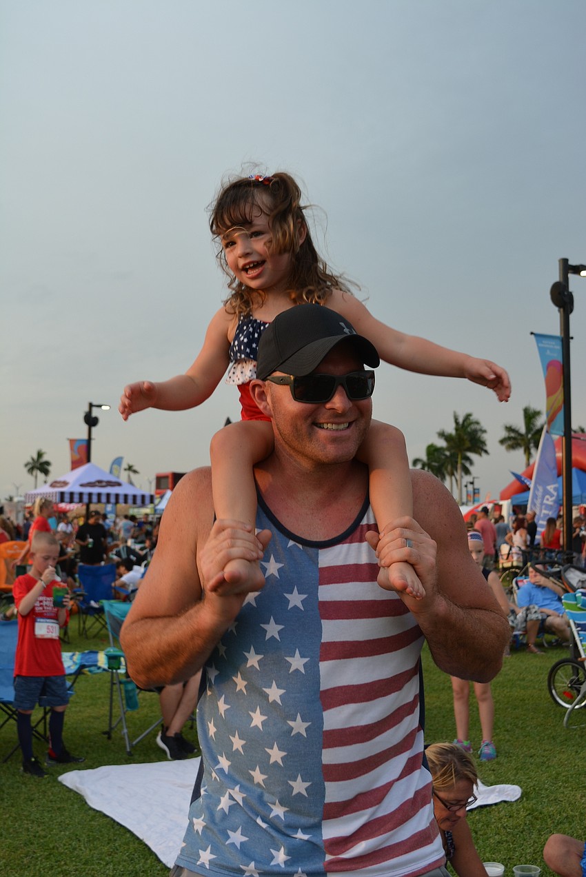 Three-year-old Parrish resident Taytum Panetta dances to The Billy Rice Band from atop the shoulders of her father, Nick Panetta. 