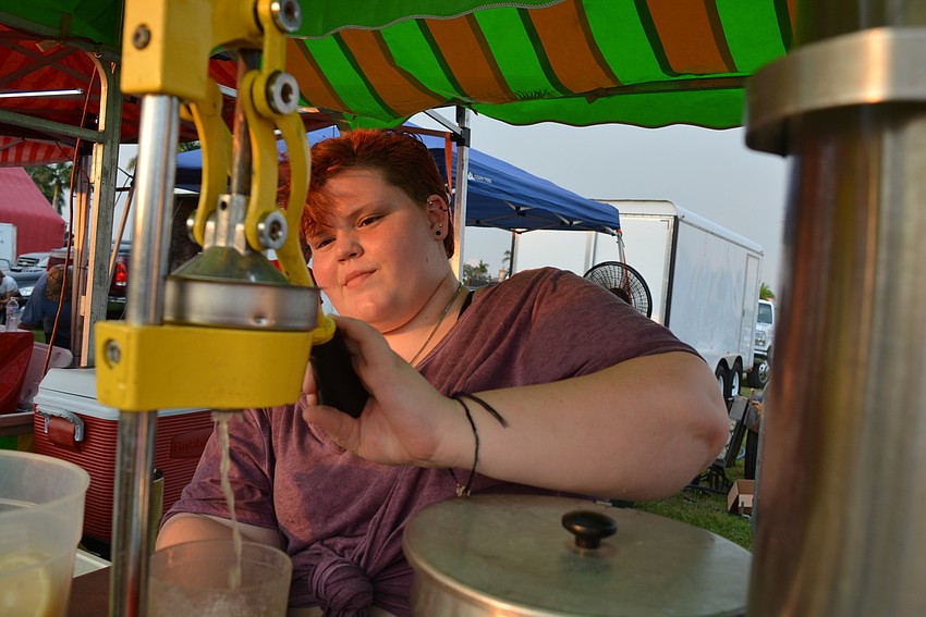 Custom Catering's Aleah Burrill makes fresh lemonade for customers with sugar, water and fresh-squeezed lemons.