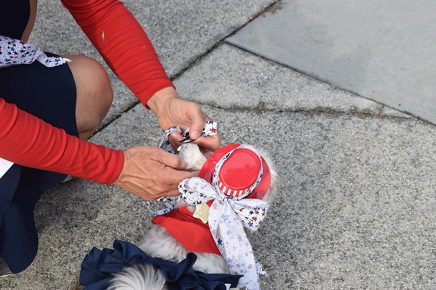 Martina Kinslow helps her dog Daisy keep her hat on.