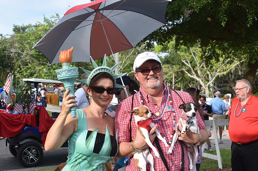 Statue of Liberty Irina LaRose lights up the parade. Steve Howard and his rescue dogs, Winston and Chico, walked in the parade this year.
