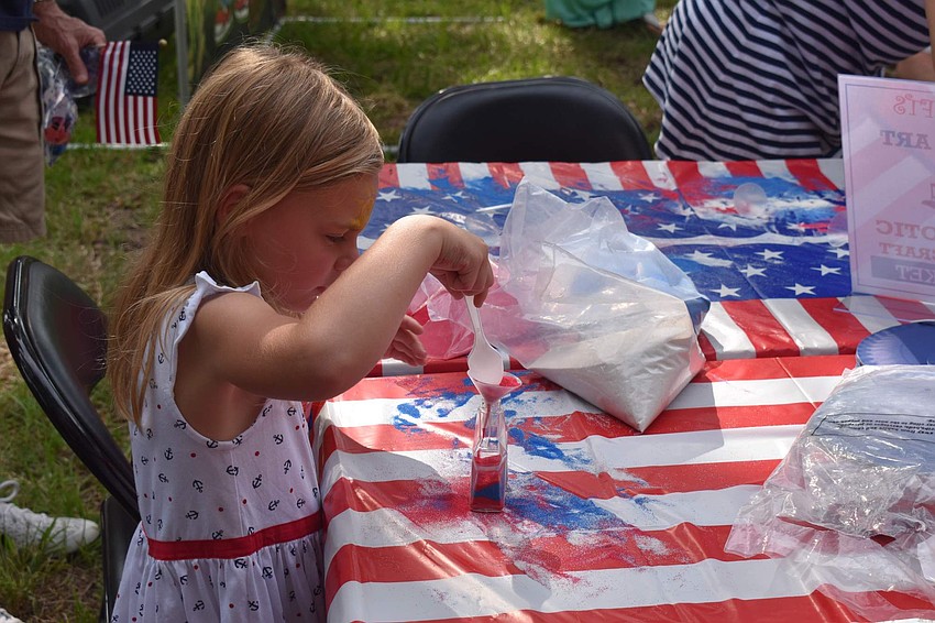 Susanna Holt crafts her red, white and blue sand art.