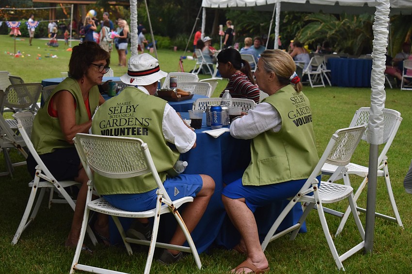 Selby volunteers Cecily Schneider, Pete Schneider and Debbie Yates ate BBQ during the event.