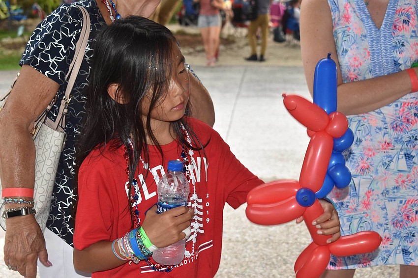 Maya Lenhardt assesses her balloon unicorn.