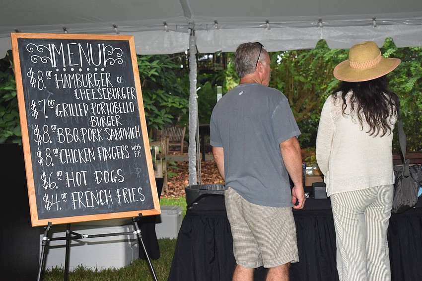 Scott and Lisa Owen order BBQ from Michael's on East, who catered the event.