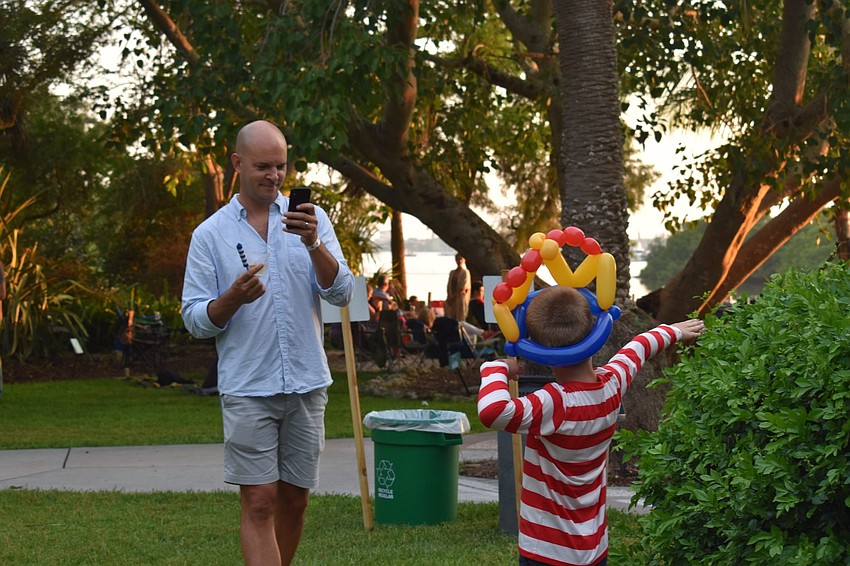 Matt Brittain takes a photo of Max Brittain posing with his balloon hat.
