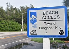 The small signs make it easy to miss Longboat Key's beach access points.