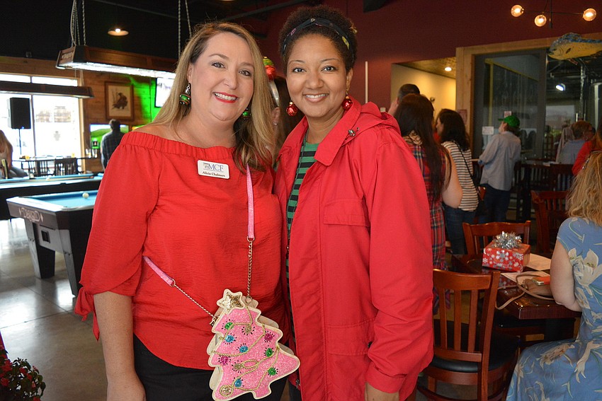 Manatee Community Foundation's Alicia Chalmers and friend Dawnyelle Singleton enjoy the Christmas theme. Both donned ornament earrings.
