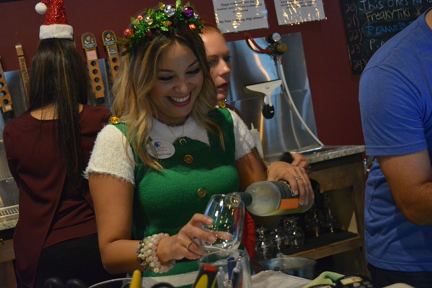 Bradenton resident  Cheers for Charity member Janibel DeJesus spends the evening tending bar. 