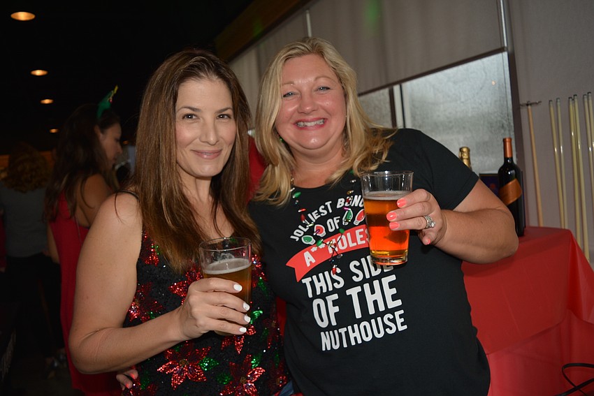 Lakewood Ranch Moms Group members Elaine Christie and Jayme Heinemann check out the raffles and other festivities. The Moms Group made the event its monthly get-together.