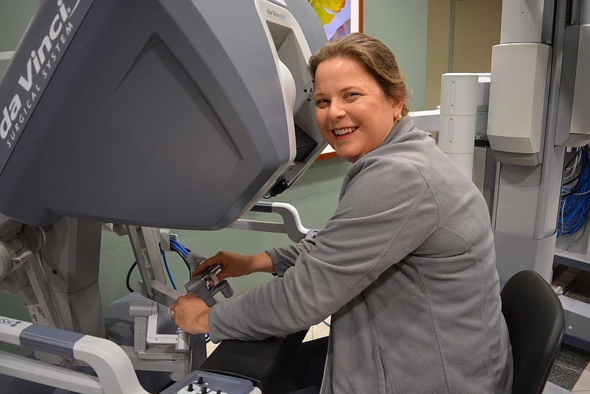 Del Tierra resident Jennifer Biery, a respiratory therapist at the hospital since 2004, tries her hand at the new Da Vinci robotic surgery equipment.