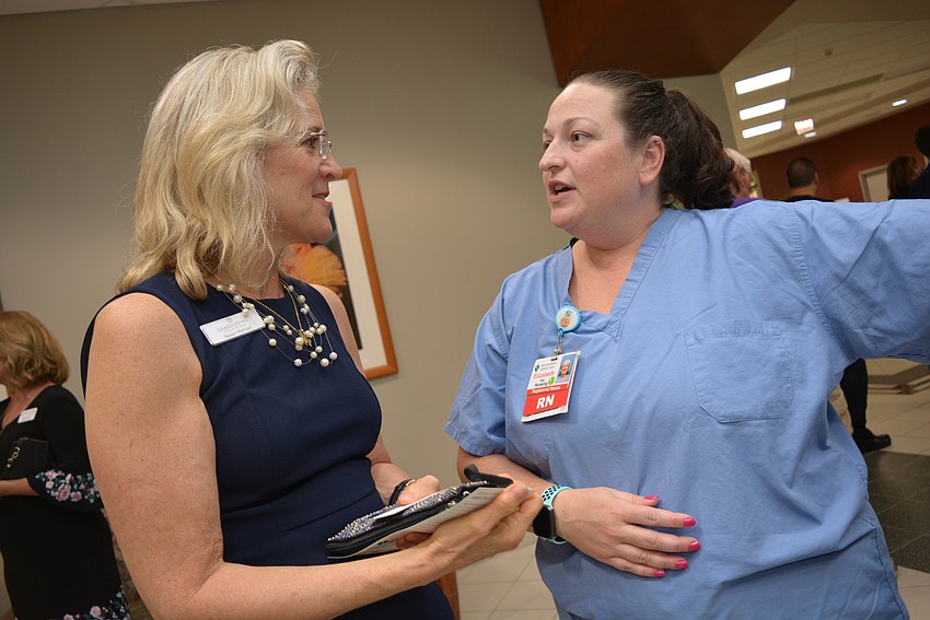 Suan Wenzel, of Grand Living, learns about the da Vinci SI Robot from robotics coordinator Elizabeth Burke.