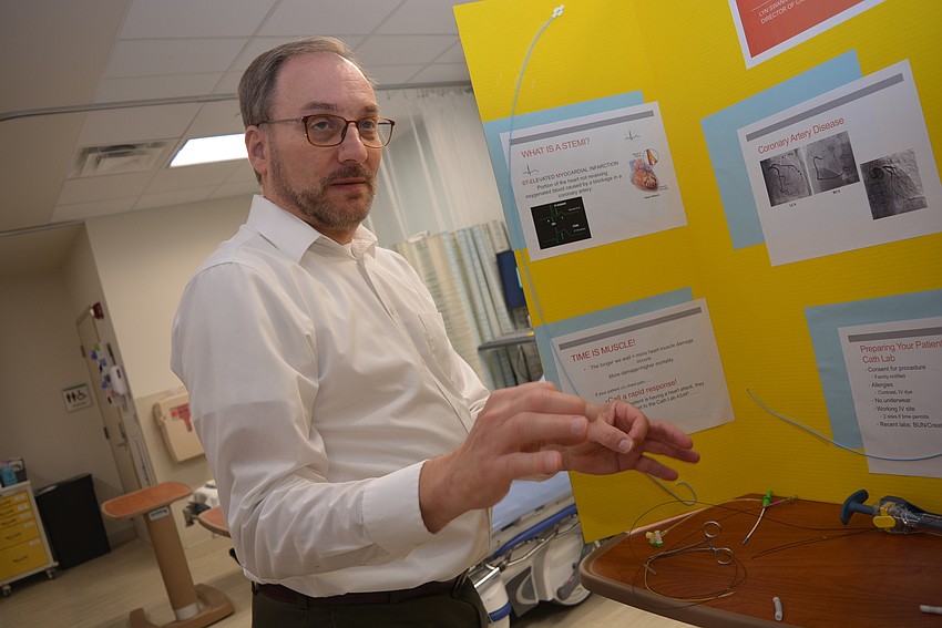 Hospitalist Dr. Andrew Faber explains to guest about how physicians identify when patients have major blood vessels closing.
