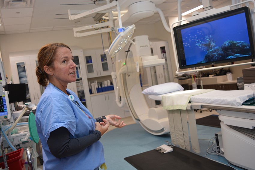 Nurse Lyn Swann shows off the new heart catheterization lab during a tour of the expansion.
