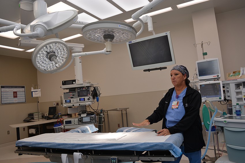 Lead nurse Pamela Coil talks about the various components of the new operating room, including lights used to focus on the area of surgery.