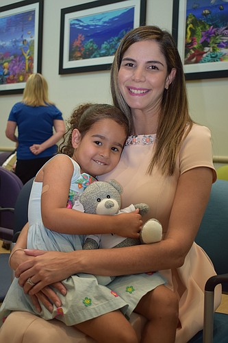 Dr. Brunel Gomez de Tavarez and her daughter, Abigail, get ready to welcome guests to an open house at the Sarasota Memorial Health Care Center at Lorraine Corners.