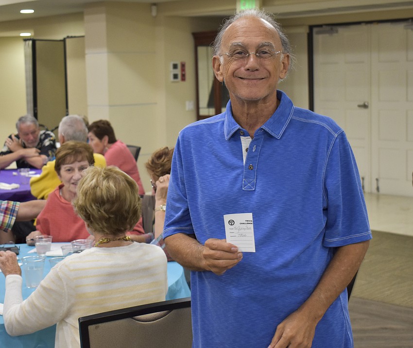 Michael Richker heads to turn in his trivia slip.