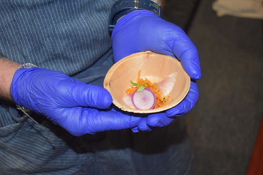 Chef Steve Phelps shows off his raw lionfish crudo.