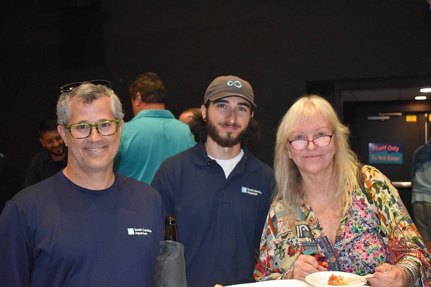 Arnold Postell and Markus Pallos, here from the South Carolina Aquarium, pose with Katherine Kelly.