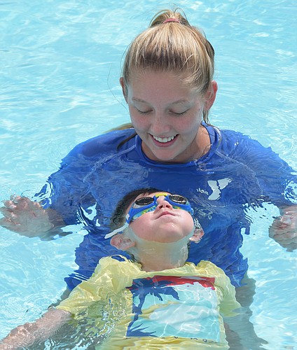 YMCA instructor Courtney Yost works with East County&#39;s Hudson Richardson.