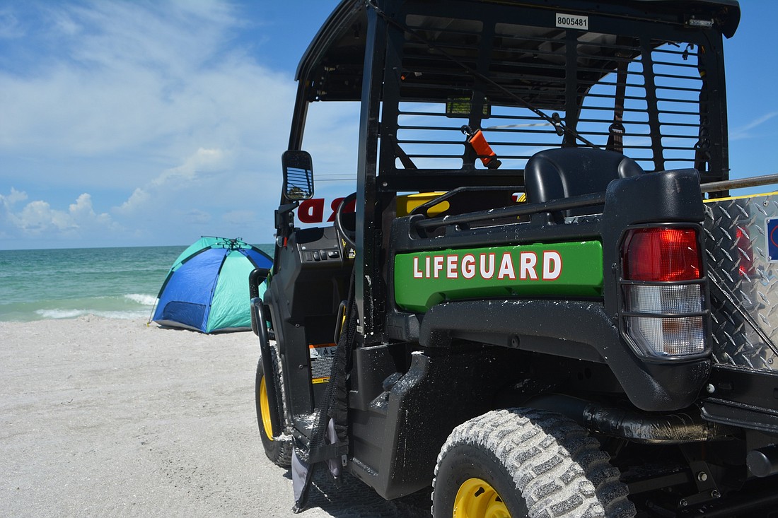 A lifeguard vehicle is on stand-by at the Lido Beach lifeguard tower