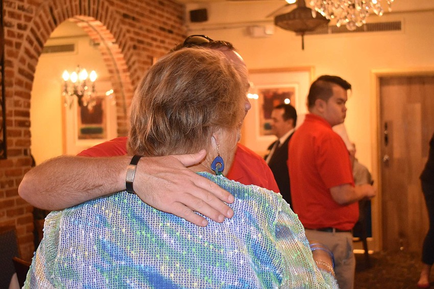 Jimmy Bonner wraps an arm around Gail Loefgren.