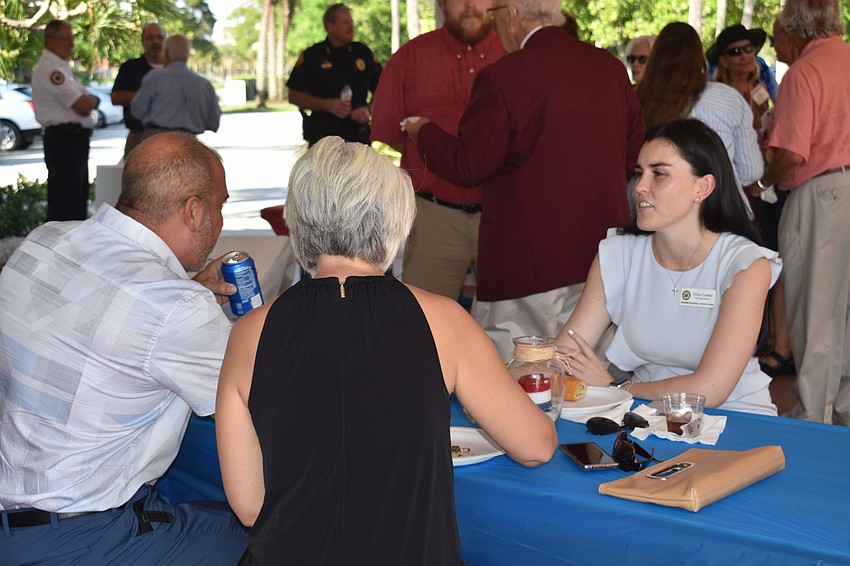 Paul and Karen DeFelice and Chloe Conboy talk at the event over food.