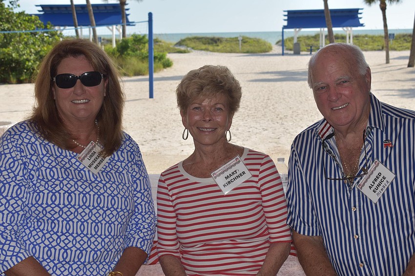 Linda Musekamp, Mary Kirchner and Alfred Eunice sit with the beach behind them.