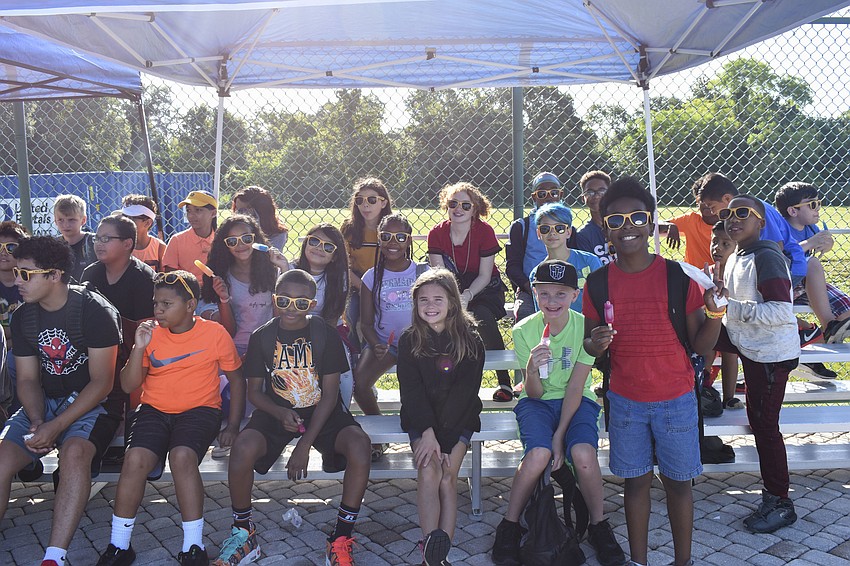 Members of the Sarasota Boys and Girls Club enjoy popsicles before the race begins.