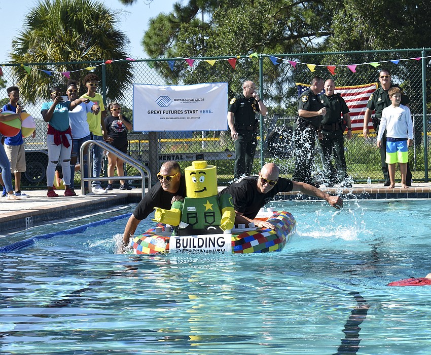 Sheriff Tom Knight and Shawn Johnson paddle with their hands in the final race.