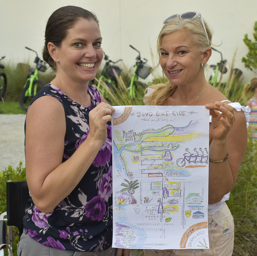 Karen Pharo and Dayle Hoffmann hold a map of the route, hand drawn by John McCarthy.