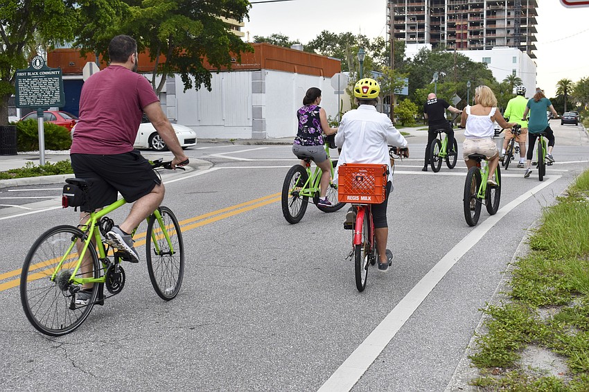 The cycists follow John McCarthy as he takes them on a tour of historic Sarasota.